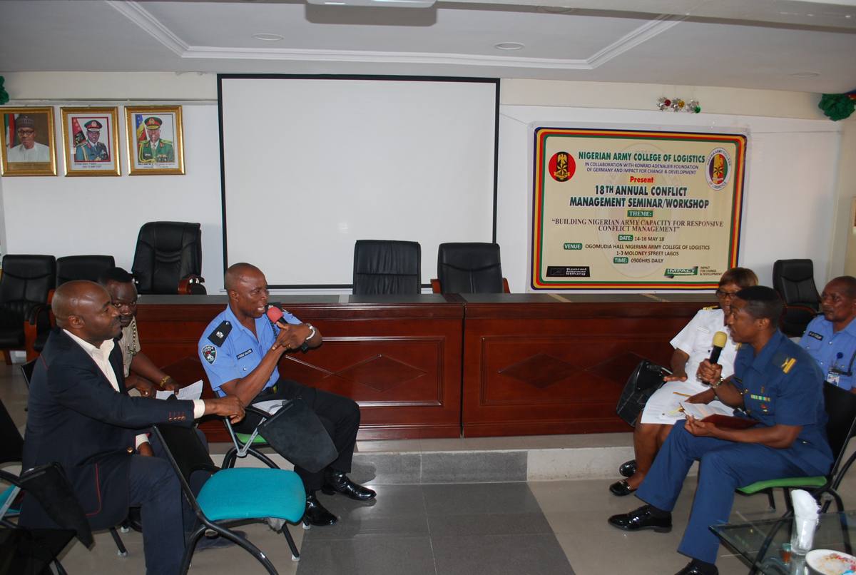 Participants at the 18th Annual Conflict Management Seminar and Workshop, Nigerian Army College of Logistics, beneath the event banner.