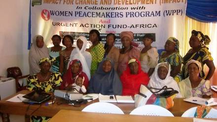 Participants seated at tables during the community healing and dialogue workshop.