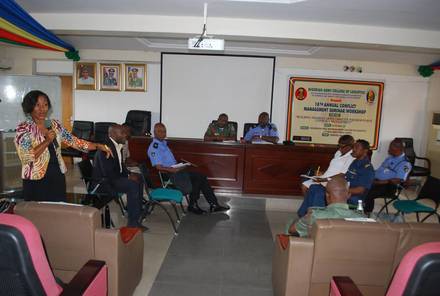 An IMPACT facilitator leading a plenary session with officers and police personnel.