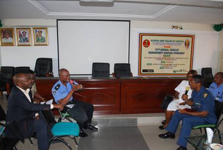 Participants seated beneath the seminar banner at the Nigerian Army College of Logistics.
